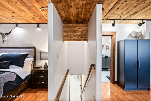 1715 Sherman Ave, Coeur Dalene, ID 83814 - bedroom featuring track lighting, wooden ceiling, and light hardwood / wood-style flooring