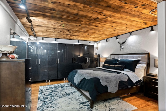 1715 Sherman Ave, Coeur Dalene, ID 83814 - bedroom with wood ceiling, rail lighting, and light wood-type flooring