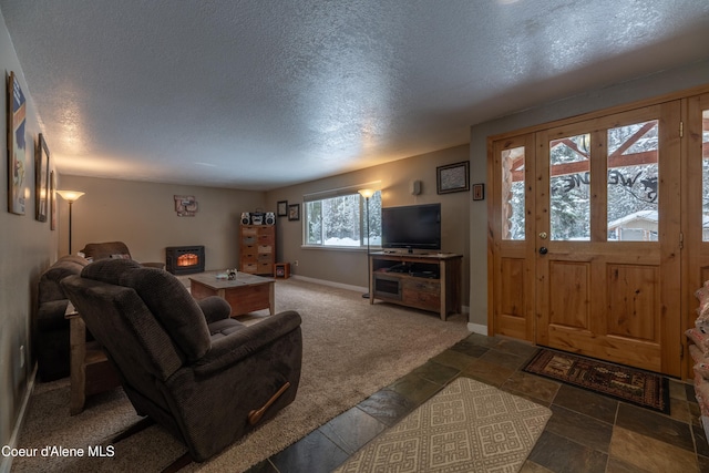 carpeted living room featuring a textured ceiling