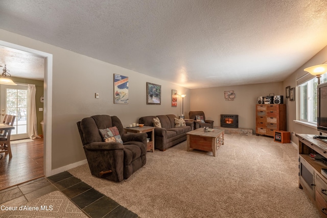 carpeted living room featuring a textured ceiling