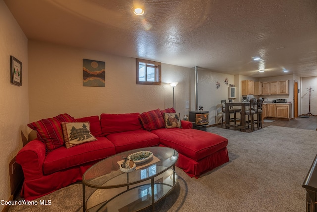 carpeted living room with a textured ceiling and a wood stove