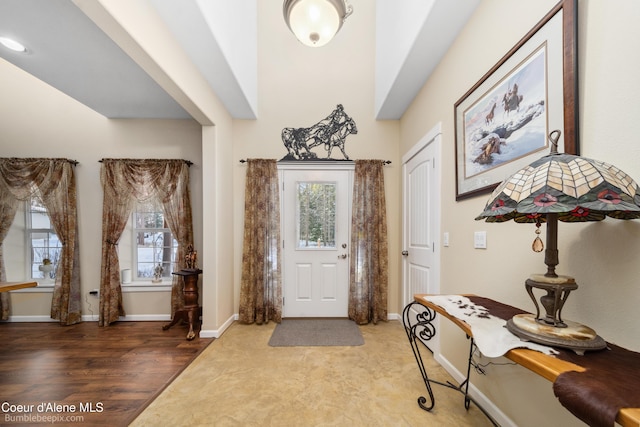 entryway featuring baseboards and wood finished floors