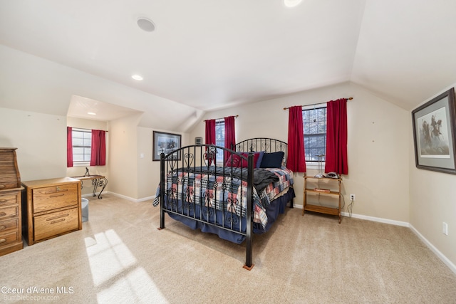 bedroom featuring vaulted ceiling, light carpet, and baseboards