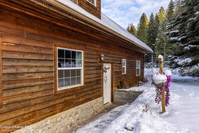 view of snow covered property entrance