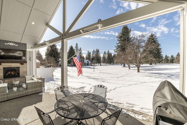 snow covered patio featuring a fireplace, visible vents, outdoor dining area, and area for grilling