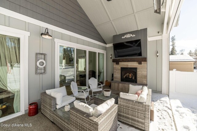 view of patio / terrace featuring an outdoor living space with a fireplace and fence