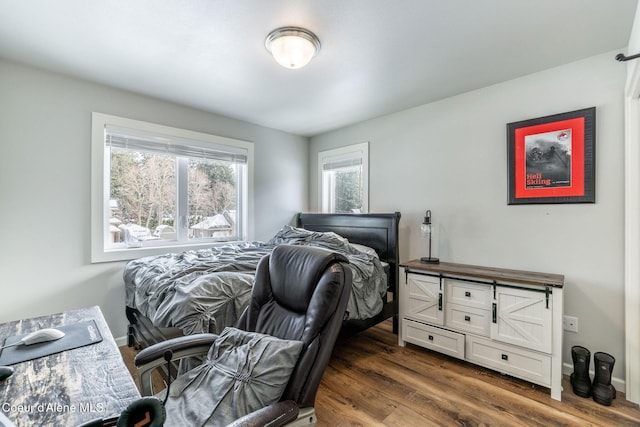 bedroom with baseboards and dark wood finished floors