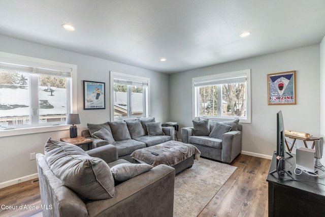 living room with a healthy amount of sunlight, baseboards, dark wood-type flooring, and recessed lighting