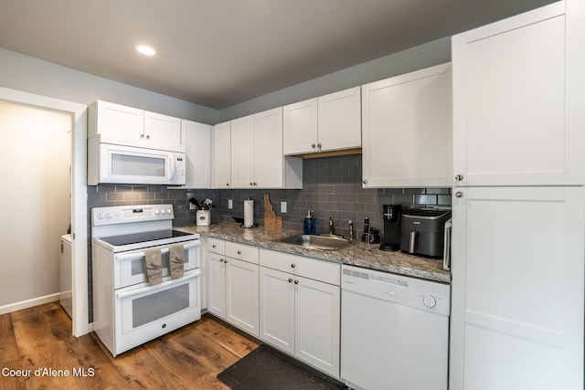 kitchen with white appliances, white cabinetry, dark wood-style floors, and a sink