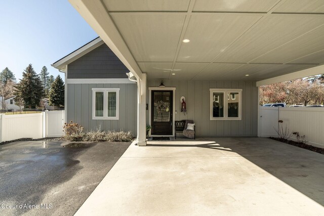 exterior space featuring a carport, fence, and a gate