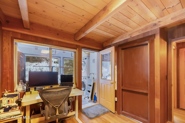 office space with stacked washer / dryer, light wood-type flooring, wood walls, wood ceiling, and beam ceiling