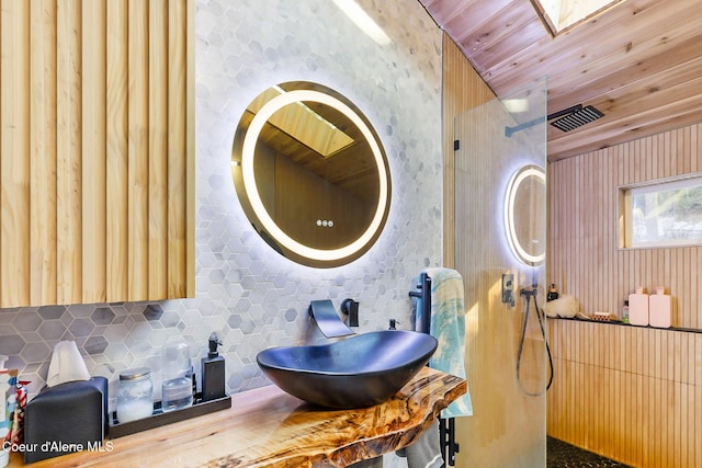 bathroom with sink, backsplash, and wooden ceiling