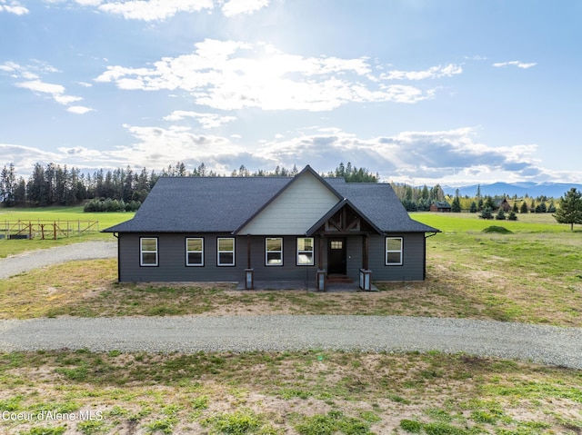 view of front of home with roof with shingles and a mountain view