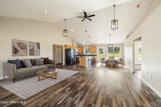 living room featuring ceiling fan, high vaulted ceiling, recessed lighting, baseboards, and dark wood finished floors