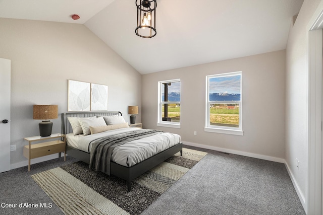 bedroom with vaulted ceiling, dark carpet, and baseboards