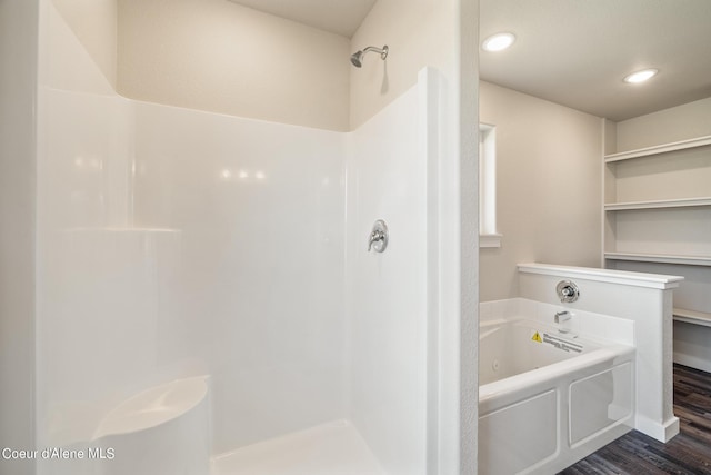 full bathroom featuring wood finished floors, a garden tub, and recessed lighting