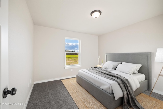 bedroom featuring carpet and baseboards