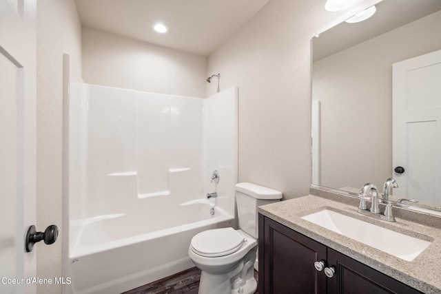 full bathroom with bathtub / shower combination, vanity, toilet, and wood finished floors