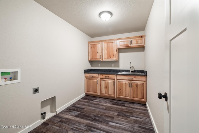 laundry room with dark wood-style flooring, hookup for a washing machine, cabinet space, a sink, and electric dryer hookup