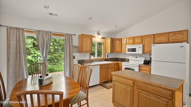 kitchen with light hardwood / wood-style flooring, sink, white appliances, and vaulted ceiling