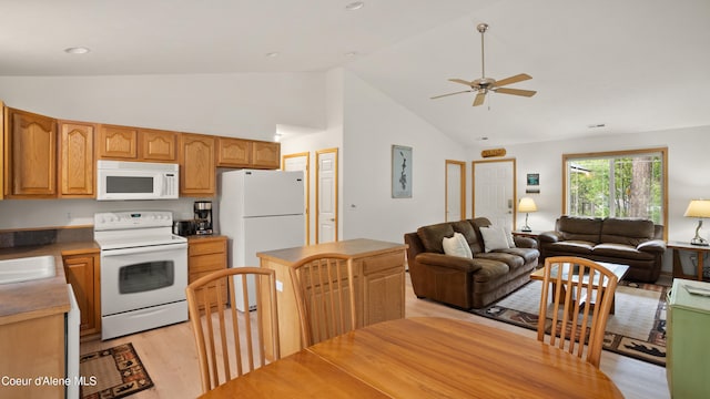 kitchen featuring sink, white appliances, high vaulted ceiling, light hardwood / wood-style flooring, and ceiling fan