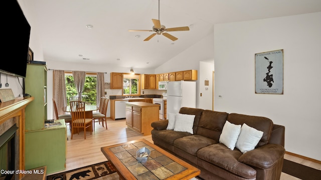 living room with high vaulted ceiling, light hardwood / wood-style floors, sink, and ceiling fan