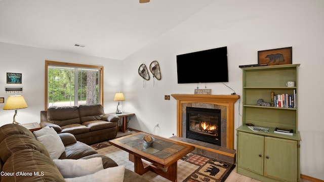 living room featuring lofted ceiling and light hardwood / wood-style floors