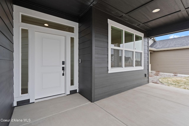 view of exterior entry with a porch