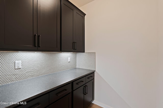 kitchen featuring decorative backsplash and dark brown cabinets