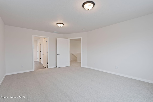 unfurnished bedroom featuring light carpet