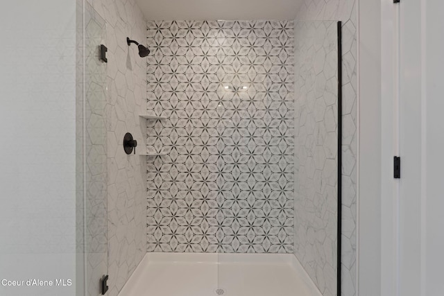 bathroom with a tile shower