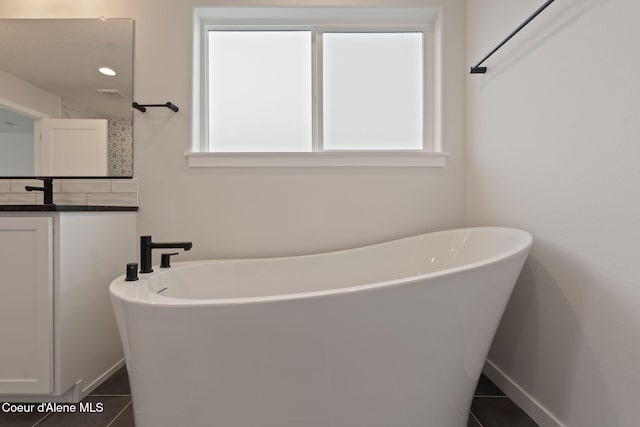 bathroom with tile patterned flooring and a bathing tub