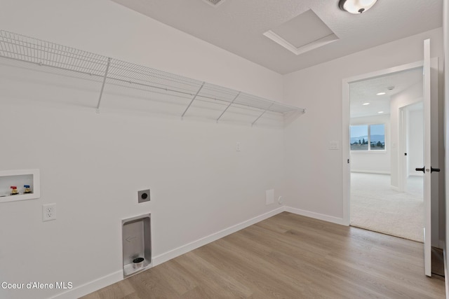 laundry room featuring washer hookup, light hardwood / wood-style floors, and hookup for an electric dryer