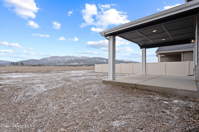 view of yard featuring a mountain view and a patio area