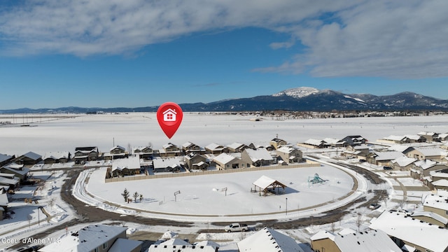 snowy aerial view featuring a mountain view