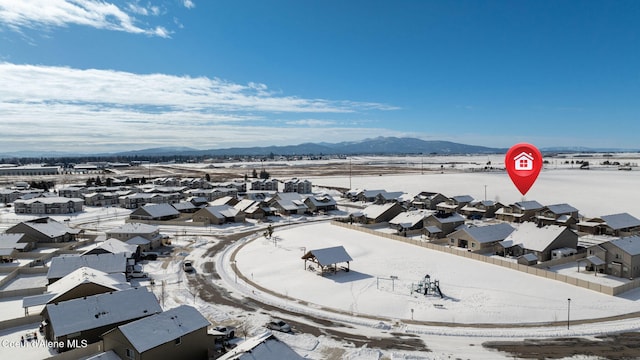 snowy aerial view featuring a mountain view