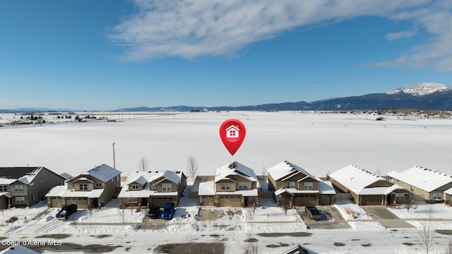 snowy aerial view featuring a mountain view