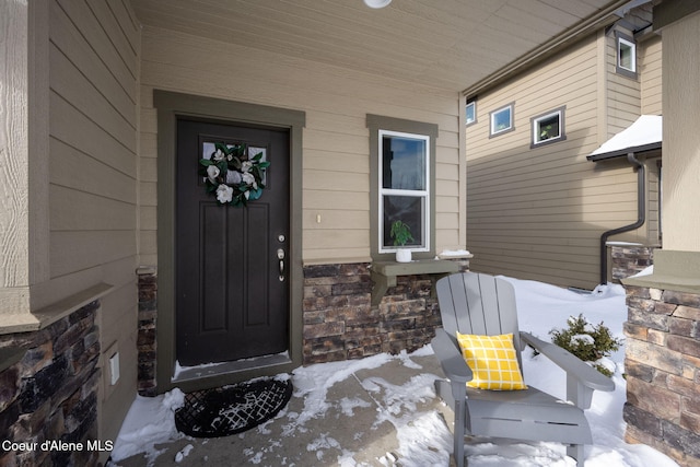 view of snow covered property entrance