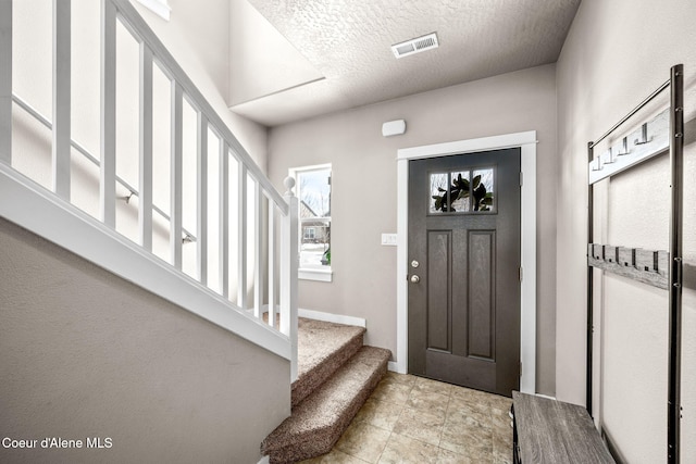 entryway with a textured ceiling