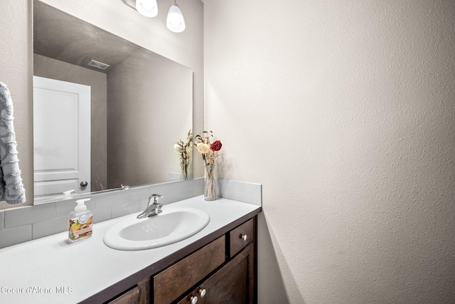 bathroom with vanity and backsplash