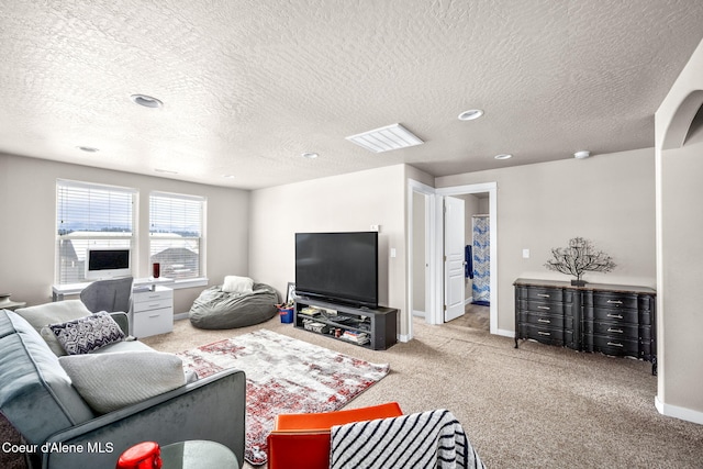 carpeted living room with a textured ceiling