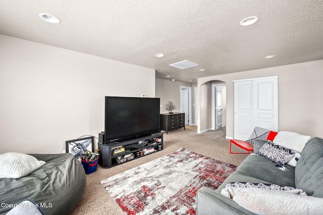 living room with light colored carpet and a textured ceiling