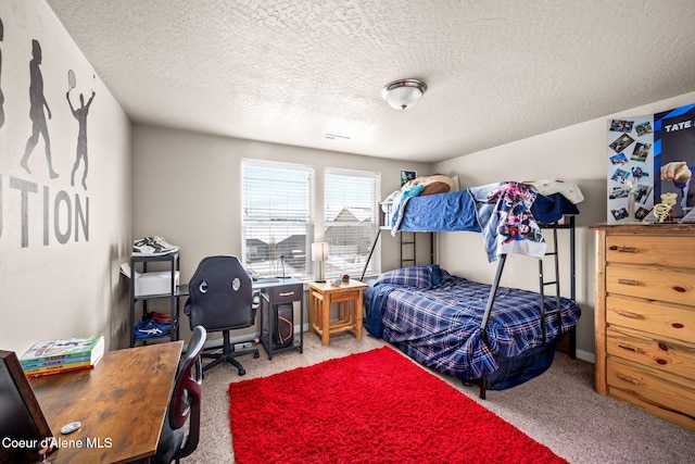 bedroom with carpet and a textured ceiling