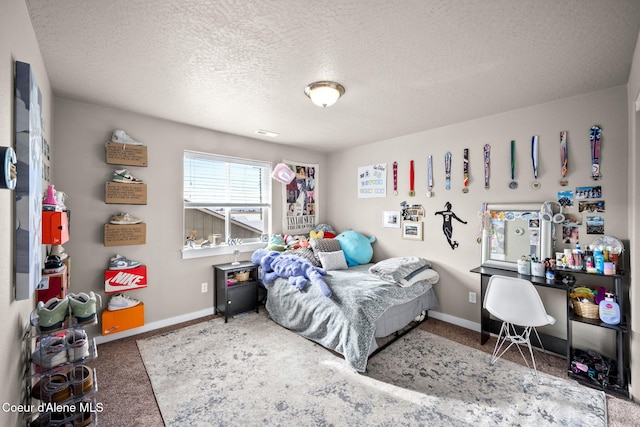 bedroom featuring carpet floors and a textured ceiling