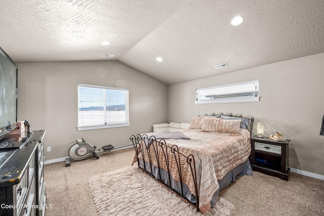 carpeted bedroom featuring multiple windows, vaulted ceiling, and a textured ceiling