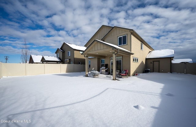 view of snow covered rear of property