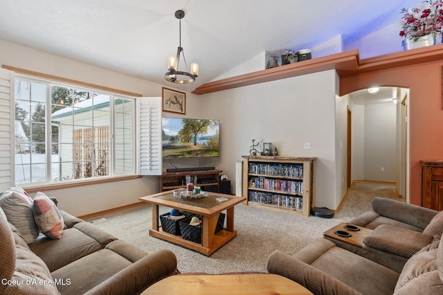 carpeted living room with vaulted ceiling and an inviting chandelier