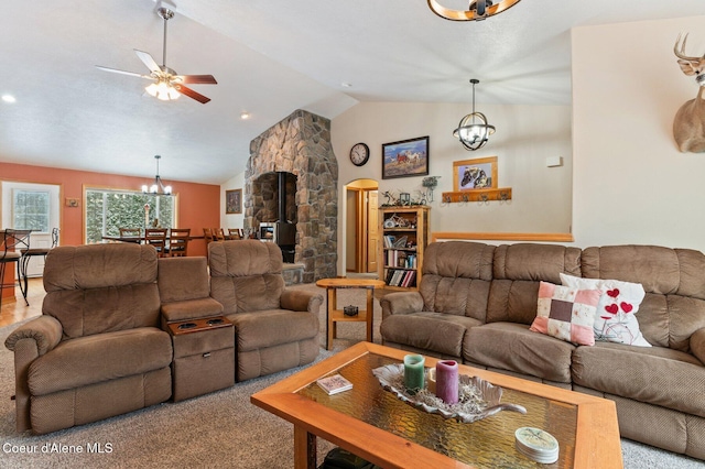 carpeted living room featuring lofted ceiling and ceiling fan with notable chandelier