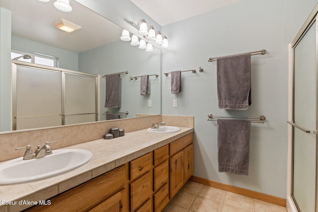 bathroom featuring tile patterned floors, vanity, and an enclosed shower