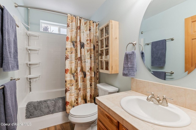 full bathroom featuring vanity, shower / tub combo, and toilet